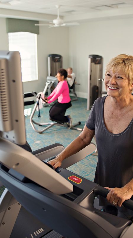 A photo of a woman exercising in the Fitness Center at the Clubhouse